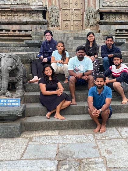 The group taking a moment to rest on the steps of the historic Belur temple, a cultural stop on our trip.