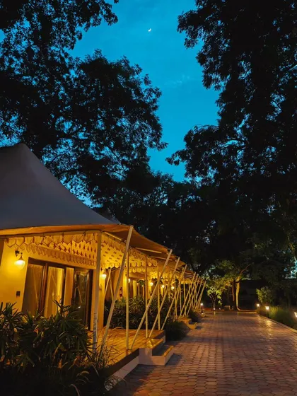 A luxury tented accommodation in Gwalior at dusk. This shot is perfect for hospitality clients, showcasing a unique and serene stay experience.
