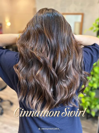 I call this look Cinnamon Swirl. It features warm, cinnamon-toned highlights painted through a dark base for a beautiful, dimensional effect that looks amazing with soft waves.