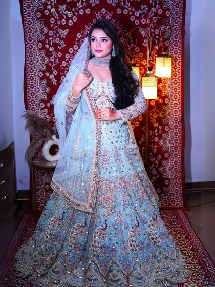 A full-length shot that captures the entire majestic look of this peacock-inspired lehenga.