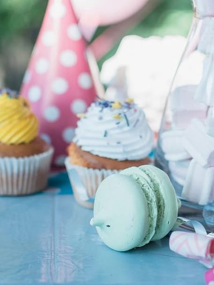 This close-up of a dessert table with cupcakes and macarons is another example from my baby shower guide. It highlights my attention to detail and ability to create sweet treats that match your party's theme.