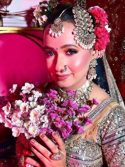 Another beautiful shot of the bridal look from my pro course. The bride is holding flowers, and the soft lighting highlights the dewy finish of the makeup and the vibrant colors.
