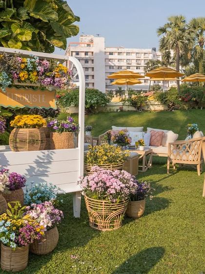 A flower stall filled with baskets of colorful blooms adds to the French market vibe of the 'Côte d'Amour' theme.