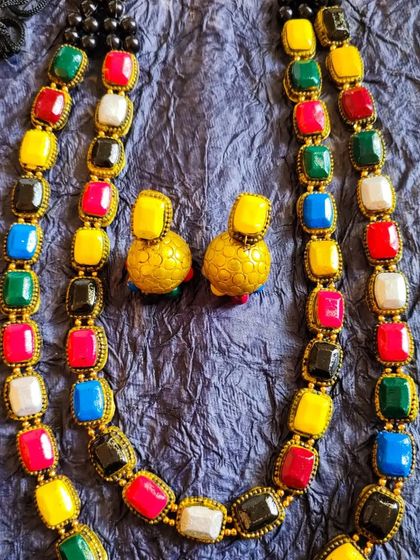 A stunning two-layered 'maharani' necklace with multi-colored stones. This is a grand, statement piece perfect for weddings and major celebrations.
