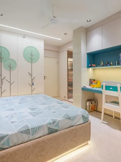 Another view of the child's room, showing the integrated design of the bed, wardrobe, and study area. The consistent use of color and motifs creates a cohesive and joyful environment.