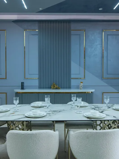 The play of light and shadow on the textured walls and the elegant place settings show how I design for a complete sensory experience.