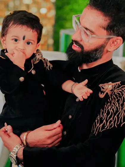 It’s not just for the ladies. I love creating matching outfits for the whole family. Here’s a father and son duo looking sharp in custom black sherwanis with matching gold tiger embroidery.