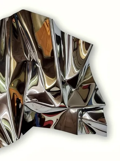 "Meteor 66," a vertical wall sculpture in polished stainless steel, whose surface mirrors its surroundings in abstract ways.
