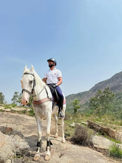 Another shot of a rider and his horse against the vast mountain landscape. These are the moments that make the challenging Nandi Hills trail worth it.