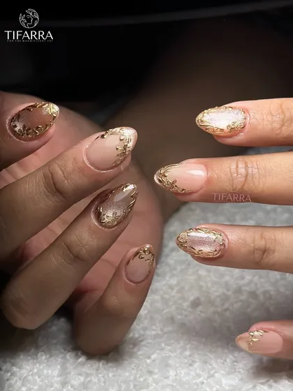 Art that is drawn, not stamped. This set features intricate golden floral borders on a mix of nude and cat-eye bases.