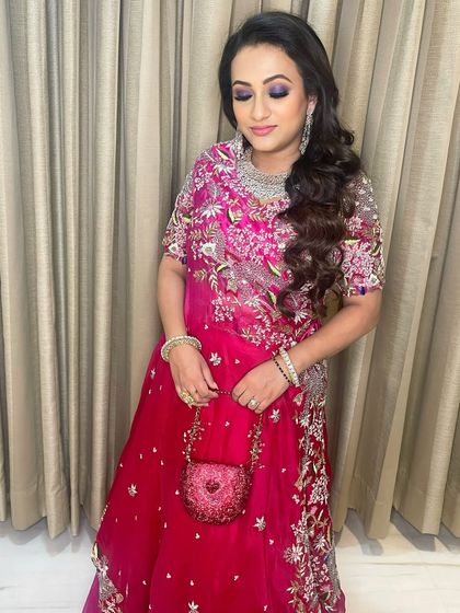 A full view of the purple smokey eye look, showing how the color enhances her features and ties the whole outfit together.