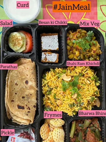 A closer look at one of my special Jain meal trays. This one features Shahi Ram Khichdi, Mix Veg, Bharwa Bhindi, Parathas, and even a Besan ki Chikki for a sweet treat, all made without onion or garlic.