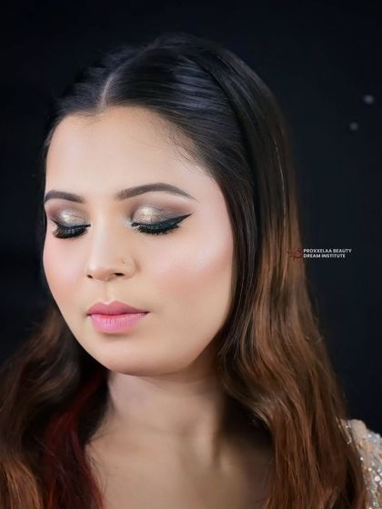 The eye makeup features a beautiful champagne shimmer on the lid and a sharp wing, a classic combination that is always in style for any party.
