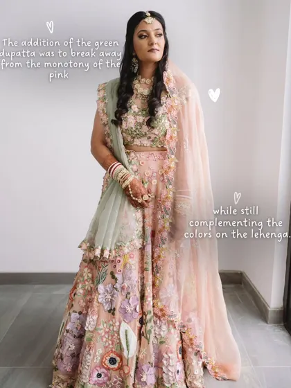 A small styling choice can make a huge impact. We added a contrasting green dupatta to this bride's pink floral lehenga to break the monotony and complement the colors in the embroidery, creating a unique and personalized bridal look.