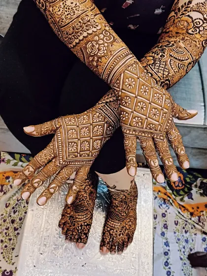 A unique way to personalize your mehndi. For this bride, I wrote the letters of her groom's name, 'FARMAN', one on each fingertip.