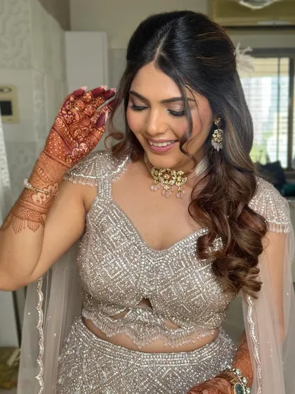 A beautiful candid moment. The half-up style is secured neatly, allowing the rest of the hair to fall in soft, defined curls.