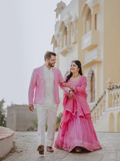 I believe couple portraits should feel natural and romantic. Here, I captured Anjali and Avanish taking a quiet walk during their Mehendi celebrations at a stunning Rajasthan palace, showcasing their connection in a timeless, elegant setting.