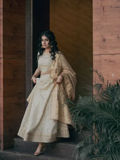 The full look for Kavya's engagement. The soft, radiant makeup perfectly complements her elegant white and gold lehenga, creating a timeless and graceful appearance.