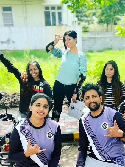 A group of graduates celebrating with their coaches. This is a team effort, and we celebrate every success together.