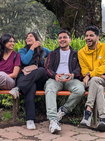 Candid laughter on a park bench. These are the moments that define our trips.