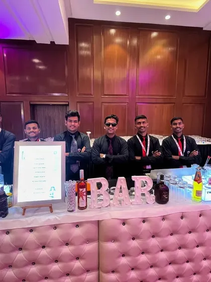 The full team behind our elegant tufted bar at a corporate conference. We present a united, professional front for your event.