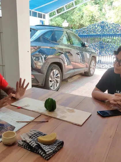 A candid moment of discussion and instruction during a workshop. These conversations are where much of the learning and connection happens.