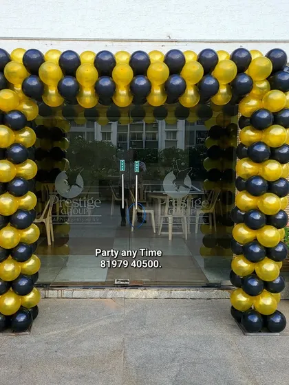 A black and gold balloon arch for a corporate event or store opening.