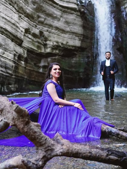 The trail of our royal blue gown drapes elegantly over the natural landscape. This gown is perfect for creating artistic and memorable pre-wedding portraits.
