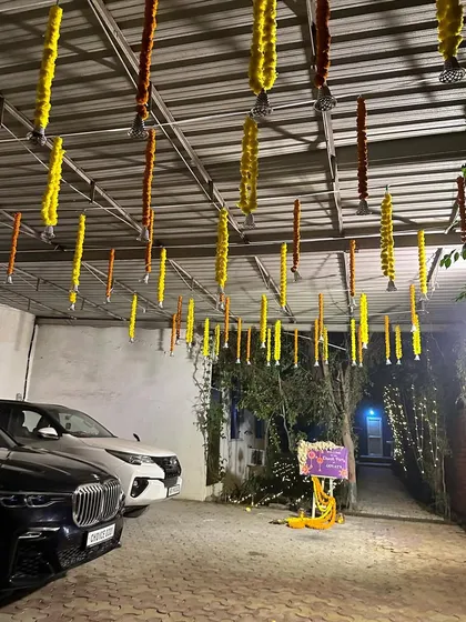 Even the parking area can be made festive. We decorated the ceiling of this carport with hanging marigold strings for a Diwali party.