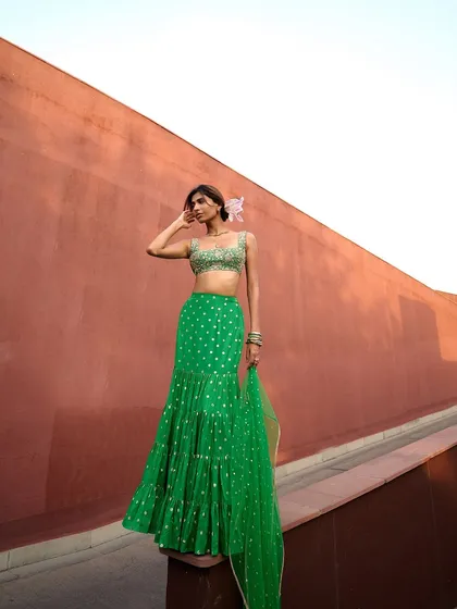 The full view of the green sharara, showcasing its tiered design and playful movement. It’s a fun and festive choice for any celebration.