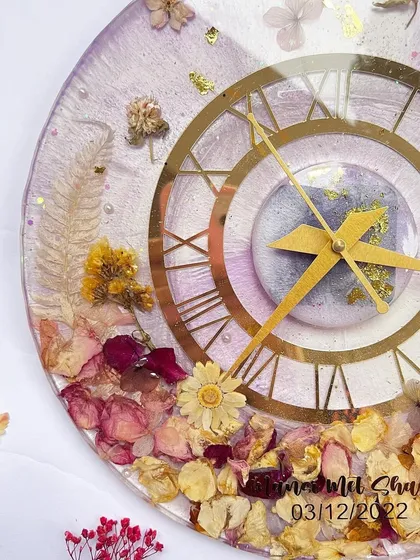Another view of the lavender clock, showing the delicate arrangement of the flowers and the custom inscription.