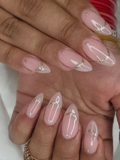 A simple and elegant design with a sheer nude base and delicate, intersecting silver glitter lines.