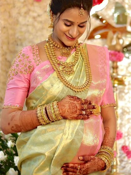 A close-up capturing the beautiful moment of a mother holding her belly. The shimmering tissue silk adds to her radiant glow.