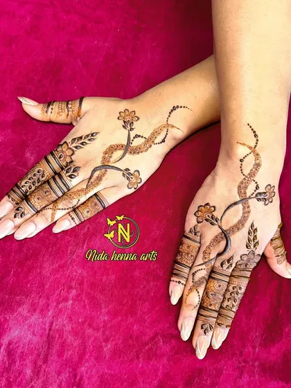 This pose shows how the minimalist vine design looks when the hands are open. It's a subtle yet beautiful style for any occasion.