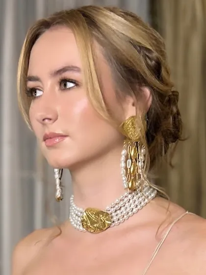 A soft and luminous makeup look for the sister of the bride at a destination wedding. We specialize in creating looks that are both stunning in person and photograph beautifully, catering to a diverse clientele from around the world.