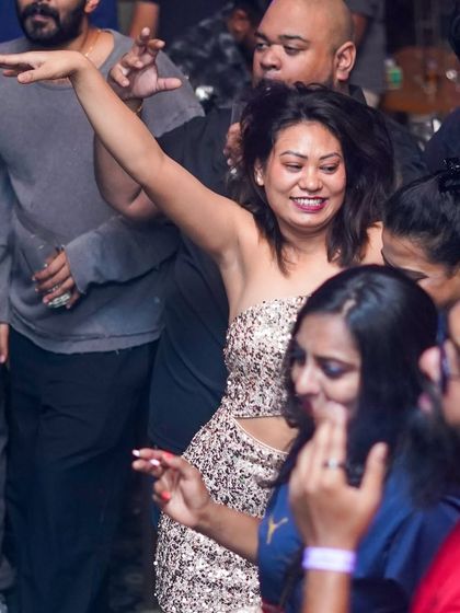 A guest in a sequined top, shining on the dance floor.