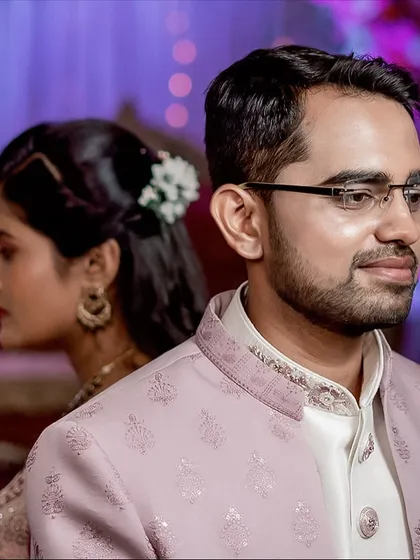 An artistic couple portrait with the groom in the foreground. This composition adds depth and tells a story of two individuals coming together.