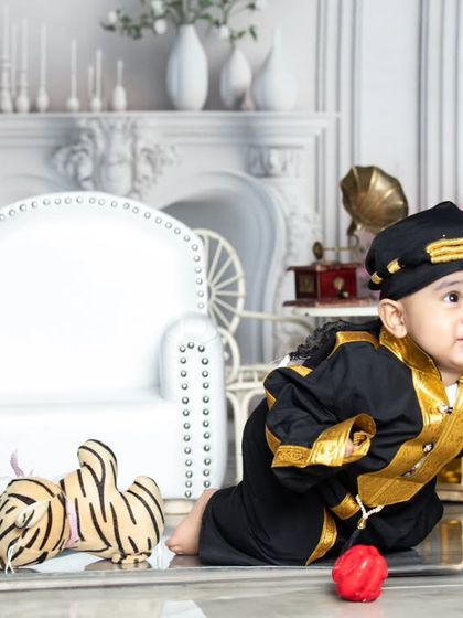A unique outfit for a unique little personality. This baby is crawling and exploring in a stylish black and gold costume.