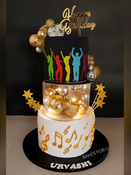 Let's get the party started with this three-tier disco-themed cake. Featuring dancing silhouettes, shimmering disco balls, and integrated fairy lights, this cake is designed to be the life of the party. It’s a great example of how I incorporate fun elements like lights and motion into my designs.