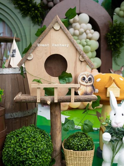 A detailed shot of a birdhouse prop from Advaith's woodland party, surrounded by greenery and adding a rustic, charming touch.