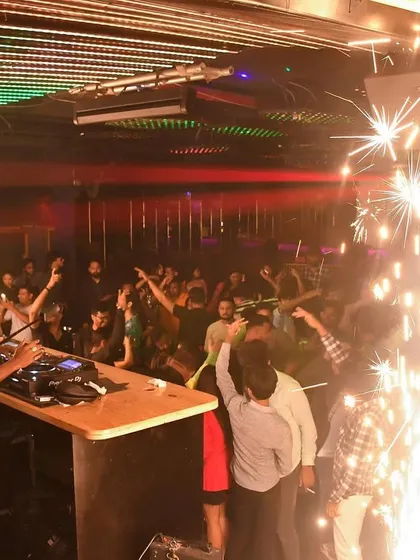 The crowd at Helium, Pune, surrounded by sparklers for a special celebration.