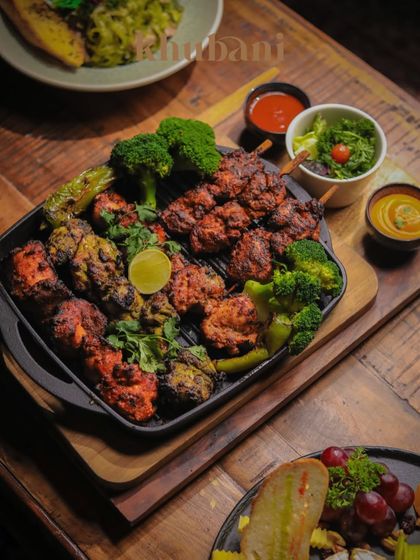 Our Grand Platter is an opulent celebration of Middle Eastern flavors. Featuring a variety of succulent kebabs and grilled vegetables, it’s an experience carved out of the region's golden kitchens.