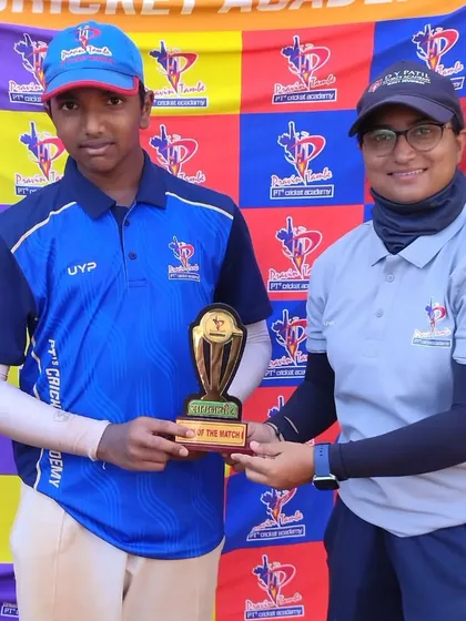 One of our female coaches presents a Man of the Match trophy, highlighting the diverse and experienced coaching staff at our academy.