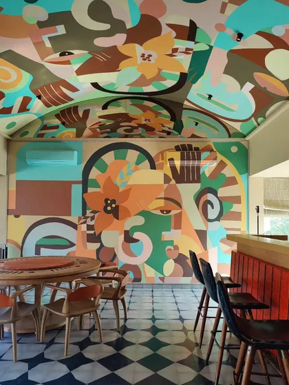 We see every surface as an opportunity, including the fifth wall. For this residential game room, the art doesn't stop at the wall but flows onto the vaulted ceiling, creating an immersive, playful environment. This hand-painted mural proves that even a space for leisure can be a sacred canvas for bold, expressive art.