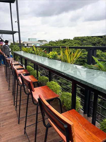 The rooftop seating at Masala Martini, lined with lush planters, offers a green view over the city. This is how I create pockets of nature in dense urban environments.