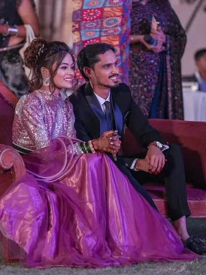 A candid shot of the couple enjoying the Sangeet performances from their seat.