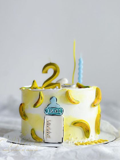 This cake theme was based on a baby's favorite things: milk, egg, and banana. We had so much fun creating this quirky and personal design for a second birthday.