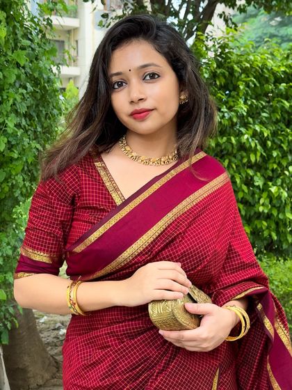 A close-up portrait to show the makeup and jewellery pairing. A simple bindi and red lip are all you need to complete this traditional look.