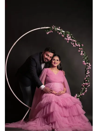 Celebrate your journey to motherhood with a beautiful couple's photoshoot. This baby pink tiered maternity gown is designed for comfort and style, and you can capture these precious moments in my in-house studio.