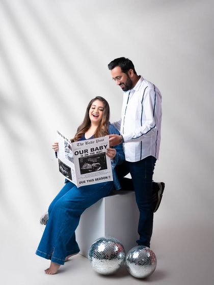 Reading the big news together! This fun announcement photo shows the couple's joyful reaction to their custom "Our Baby" newspaper.